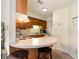 Small kitchen with wood cabinets and bar at 1204 Erin Way # 1204-F, Myrtle Beach, SC 29577