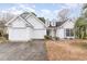 White two-story house with double garage and landscaping at 1228 Lanterns Rest Rd., Myrtle Beach, SC 29579
