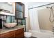 Bathroom with a shower/tub combo and unique wood-paneled walls at 272 Old Ashley Loop, Pawleys Island, SC 29585