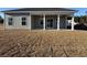 View of the backyard featuring a covered patio and ample green space at 301 Palmetto Sand Loop, Conway, SC 29527