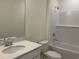Clean bathroom features a shower and tub combo with white tiled backsplash and quartz countertop vanity at 301 Palmetto Sand Loop, Conway, SC 29527