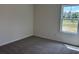 Corner bedroom with plush carpeting and natural light flooding the space from the double paned window at 301 Palmetto Sand Loop, Conway, SC 29527