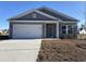 Charming one-story home featuring a two-car garage and a well-maintained front yard at 301 Palmetto Sand Loop, Conway, SC 29527