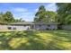 Spacious backyard with lush green grass, mature trees, and a patio area, perfect for outdoor entertaining at 4502 Boxwood St., Myrtle Beach, SC 29577
