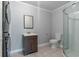 This bathroom features a modern vanity and a glass-enclosed shower with neutral tile flooring and stacked washer/dryer at 4502 Boxwood St., Myrtle Beach, SC 29577