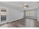 Spacious bedroom with wood floors, ceiling fan, and access to a private patio at 4502 Boxwood St., Myrtle Beach, SC 29577