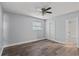 The bedroom has wood-look floors, a ceiling fan, and sliding closet doors near the bathroom at 4502 Boxwood St., Myrtle Beach, SC 29577