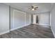 This bedroom has a brick accent wall, wood-look floors, a ceiling fan, and neutral paint at 4502 Boxwood St., Myrtle Beach, SC 29577