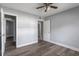 This bedroom has wood-look floors, a ceiling fan, and multiple doors leading to other rooms at 4502 Boxwood St., Myrtle Beach, SC 29577