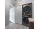 This laundry area features a stacked washer and dryer in a closet with a view to another bathroom at 4502 Boxwood St., Myrtle Beach, SC 29577