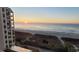 Serene beach view at sunrise, showcasing the ocean, sand, and nearby building at 4719 S Ocean Blvd. # 609, North Myrtle Beach, SC 29582