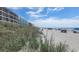 Scenic beach view featuring the ocean, dunes, and beachgoers at 4719 S Ocean Blvd. # 609, North Myrtle Beach, SC 29582