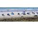 Scenic beach view with lush greenery, beachgoers, and ocean umbrellas at 4719 S Ocean Blvd. # 609, North Myrtle Beach, SC 29582