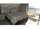 Comfortable bedroom featuring a plush bed and private balcony access with ocean views at 4719 S Ocean Blvd. # 609, North Myrtle Beach, SC 29582