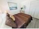 Cozy bedroom featuring a comfortable queen-sized bed with decorative pillows, mirror, and closet at 4719 S Ocean Blvd. # 609, North Myrtle Beach, SC 29582