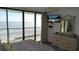 Relaxing bedroom featuring balcony access with ocean view, flat screen TV, and tasteful decor at 4719 S Ocean Blvd. # 609, North Myrtle Beach, SC 29582