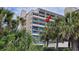 Coastal condominium with a private balcony showcasing ocean views and lush tropical foliage at 4719 S Ocean Blvd. # 609, North Myrtle Beach, SC 29582