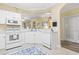 Well-equipped kitchen with white appliances and countertops, connected to the breakfast bar at 5650 Barefoot Resort Bridge Rd. # 223, North Myrtle Beach, SC 29582