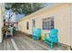 Relaxing deck with teal chairs and yellow table, adjacent to the home at 6001 - D07 S Kings Hwy., Myrtle Beach, SC 29575