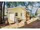 Yellow cottage with AC unit and wooden deck at 6001 - D07 S Kings Hwy., Myrtle Beach, SC 29575