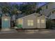 Yellow cottage at night, showing lights and teal accents at 6001 - D07 S Kings Hwy., Myrtle Beach, SC 29575