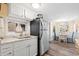 Kitchen with white cabinets, granite counters, and stainless steel fridge at 6001 - D07 S Kings Hwy., Myrtle Beach, SC 29575