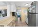 Kitchen with breakfast bar, stainless steel appliances, and view of bedroom at 6001 - D07 S Kings Hwy., Myrtle Beach, SC 29575