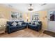 Bright living room with two blue couches and wood floors at 6001 - D07 S Kings Hwy., Myrtle Beach, SC 29575