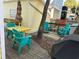 Outdoor patio with yellow table, teal chairs, and umbrella at 6001 - D07 S Kings Hwy., Myrtle Beach, SC 29575