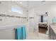 Bright bathroom with a tiled shower, granite counters, and access to a bedroom at 6550 Anterselva Dr., Myrtle Beach, SC 29572