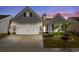 Charming single-Gathering home boasts an attached two-car garage, manicured lawn, and inviting curb appeal at 6550 Anterselva Dr., Myrtle Beach, SC 29572
