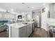 Modern kitchen features a large island, stainless steel appliances, and an open view into the living room at 6550 Anterselva Dr., Myrtle Beach, SC 29572