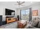 Living room featuring a large TV, comfortable seating, and natural light at 6550 Anterselva Dr., Myrtle Beach, SC 29572