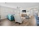 Well-lit living room boasts hardwood floors, modern furnishings, and large windows that allow ample natural light at 6550 Anterselva Dr., Myrtle Beach, SC 29572