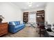 Office room showcasing built-in bookshelves, desk, and comfortable blue sofa at 6550 Anterselva Dr., Myrtle Beach, SC 29572