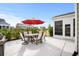 Outdoor patio with dining set and red umbrella, ideal for al fresco meals and gatherings at 6550 Anterselva Dr., Myrtle Beach, SC 29572