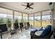 Enclosed sunroom featuring neutral decor and backyard views, creating a peaceful retreat at 6550 Anterselva Dr., Myrtle Beach, SC 29572