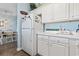 White kitchen with refrigerator and coffee bar at 1058 Sea Mountain Hwy. # 11-303, North Myrtle Beach, SC 29582