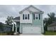 Charming two-story home featuring a 2-car garage, light-blue siding and black window shutters at 1106 Barrington Way, Conway, SC 29526