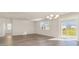 Bright living room with wood-look floors, sliding glass door and modern chandelier at 1106 Barrington Way, Conway, SC 29526