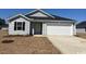 Charming single-story home featuring vinyl siding, a two-car garage, and a well-maintained lawn at 1530 Clubstone Dr., Conway, SC 29526