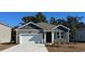 Charming house with gray siding, white garage door, and landscaping at 179 Calm Dr., Little River, SC 29566