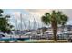 Boats docked at a marina with palm trees and buildings in the background at 179 Calm Dr., Little River, SC 29566