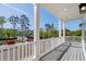 Wide balcony with white posts and gray decking overlooking a lush, green landscape and blue skies at 2302 Seaseeker Ln., Myrtle Beach, SC 29577