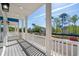This expansive balcony features white railings and supports with gray wood flooring and blue skies at 2302 Seaseeker Ln., Myrtle Beach, SC 29577