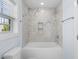Modern bathroom with a tiled shower/tub and a window providing natural light at 2302 Seaseeker Ln., Myrtle Beach, SC 29577