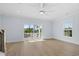 Spacious bedroom featuring a ceiling fan, natural light, and wood floors with sliding glass doors to the balcony at 2302 Seaseeker Ln., Myrtle Beach, SC 29577