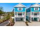 Charming two-story coastal home with a blue exterior, white trim, and a convenient drive-under garage at 2302 Seaseeker Ln., Myrtle Beach, SC 29577