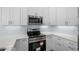 Clean kitchen with stainless steel appliances, quartz countertops, and modern white cabinets for a sleek design at 2302 Seaseeker Ln., Myrtle Beach, SC 29577