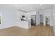 Bright, modern kitchen features stainless steel appliances, white cabinetry and an eat-in island with wooden floors at 2302 Seaseeker Ln., Myrtle Beach, SC 29577